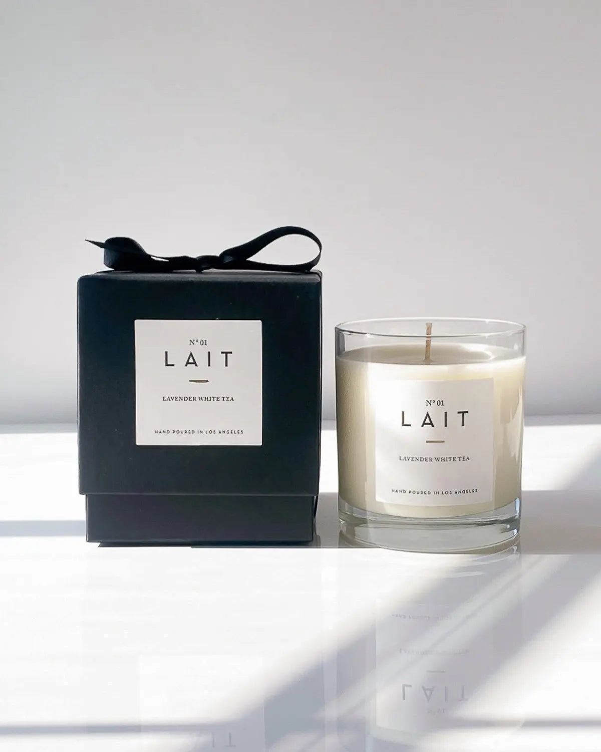 A luxurious minimally designed candle and black gift box/